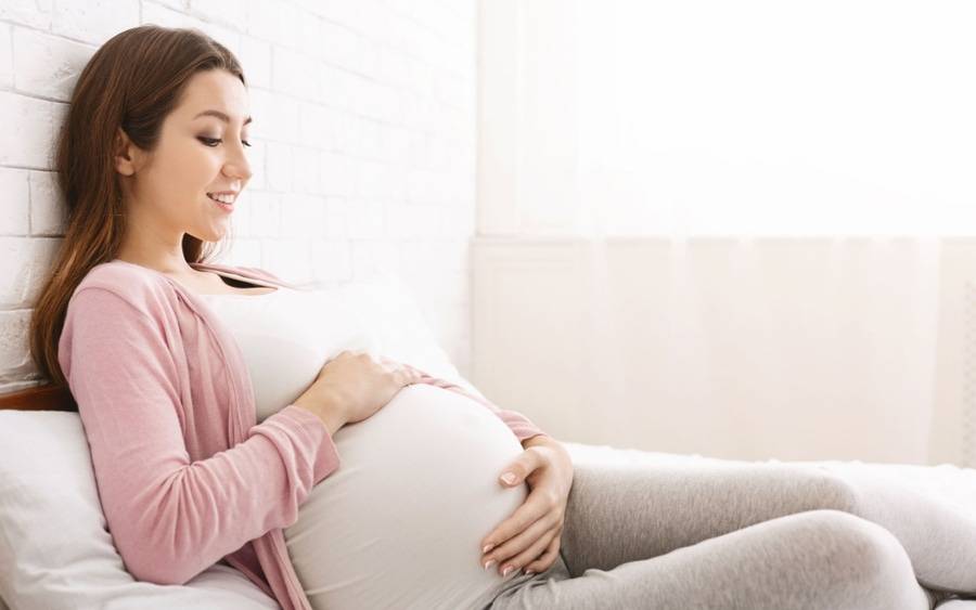 A pregnant woman rests at home at 34 week pregnancy point.