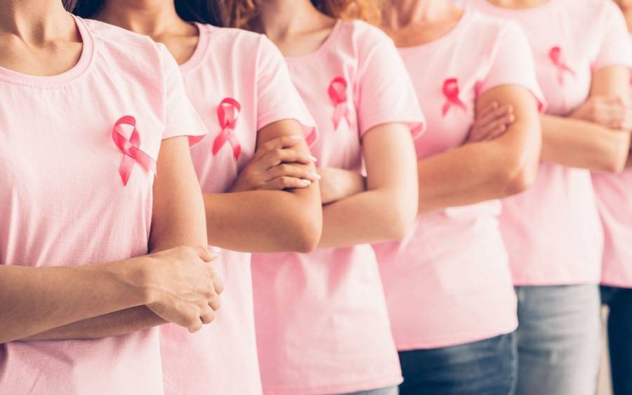 A group of women wearing shirts with breast cancer awareness ribbons, underscoring importance of early detection and mammograms