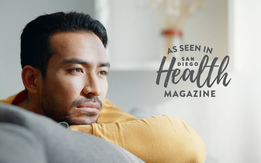 A middle-aged man rests his head on his arm looking sad. SD Health Magazine