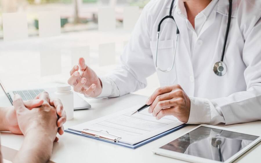 A physician and patient discussing epilepsy test results. 