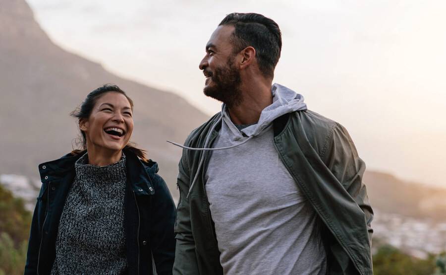 A young couple hikes a scenic trail, representing how Scripps Health is here for good in San Diego.