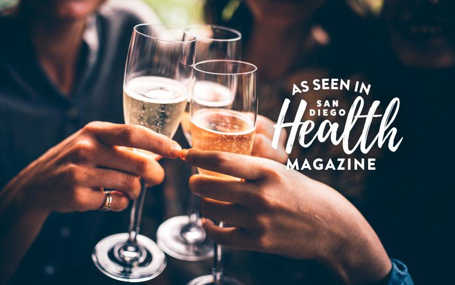 Friends and family do a champagne toast during a holiday gathering. SD Health Magazine