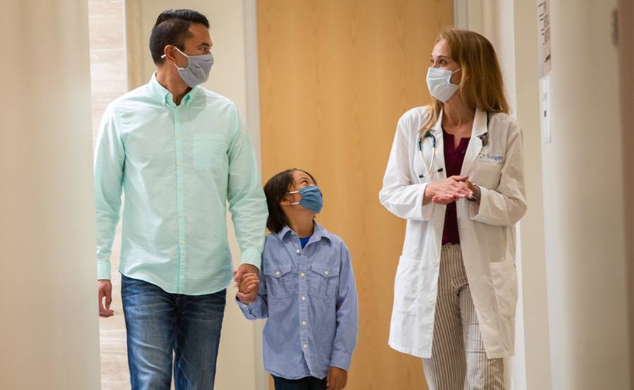 Doctor with male patient and son