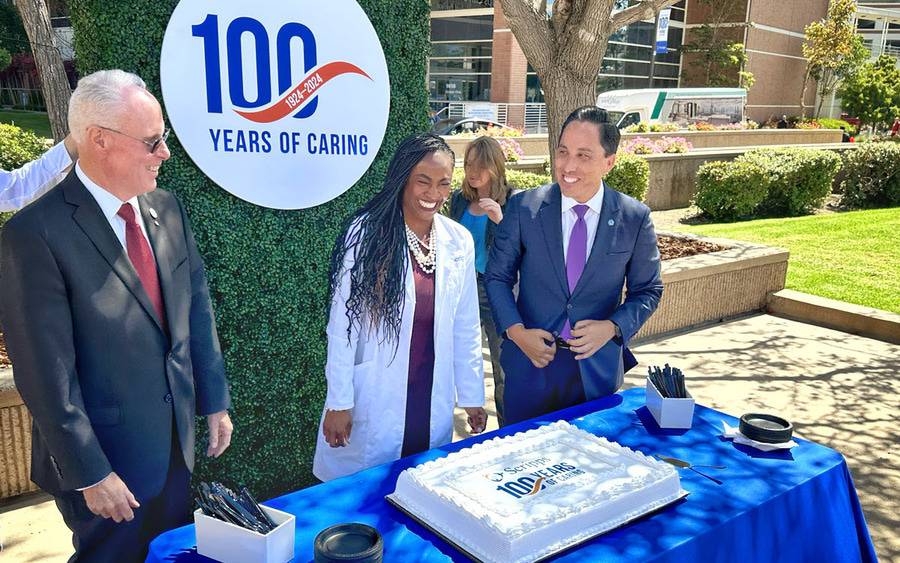 Scripps Health President and CEO Chris Van Gorder, Scripps Memorial Hospital La Jolla Chief of Staff Ayana Boyd King, DO, and San Diego Mayor Todd Gloria prepare to cut a special cake celebrating Scripps 100th Anniversary. 