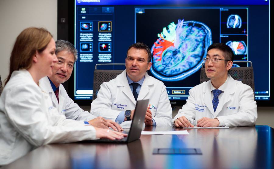 A group of Scripps Cancer Center oncologists review cancer diagnostic images related to physician referrals.