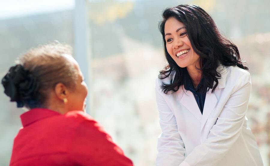 A female Scripps cancer doctor embraces a female cancer patient, representing why you should choose Scripps for cancer care.