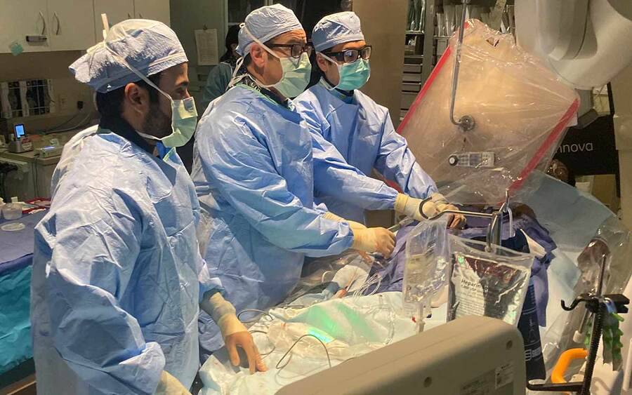 A trio of Scripps cardiologists in a surgery setting perform the region's first new high blood pressure procedure.