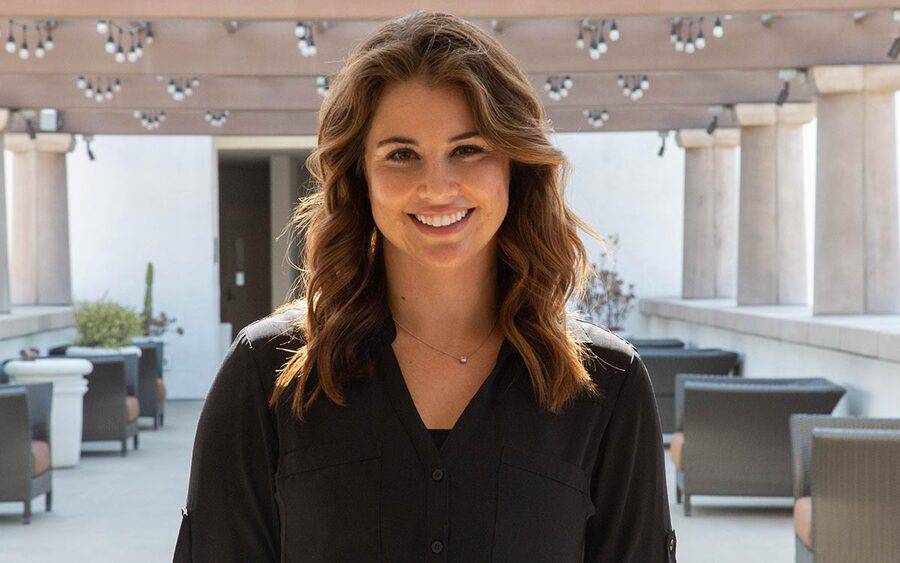 A smiling young woman in a black blouse, represents a Scripps nutrition expert who was featured in Cancer Today Magazine.