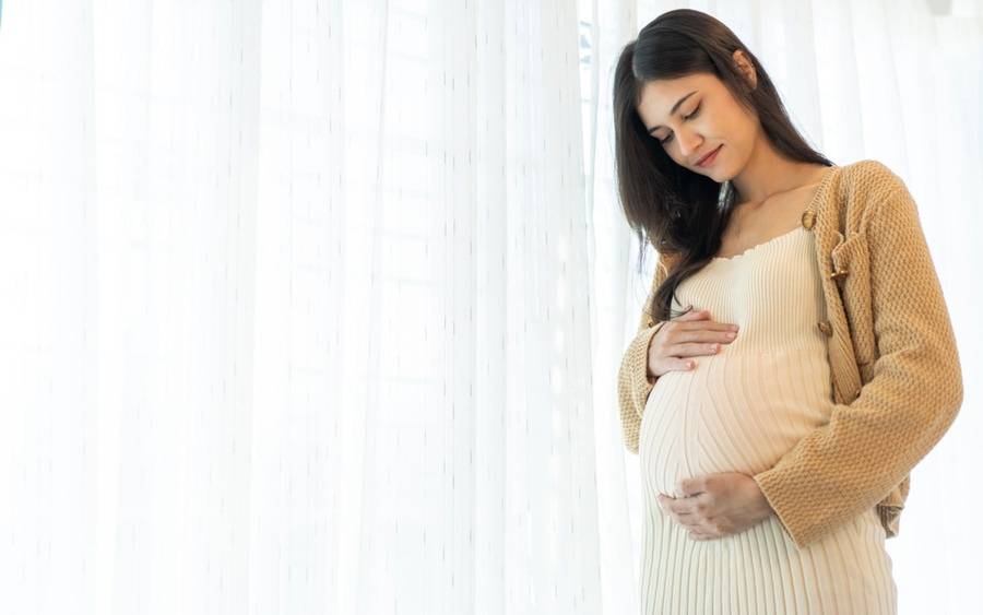 A pregnant woman contemplates creating a birth plan to document her wishes for labor and delivery.