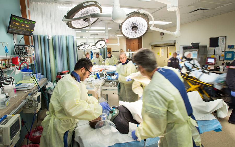 Providers in the emergency room caring for a patient who has suffered trauma.