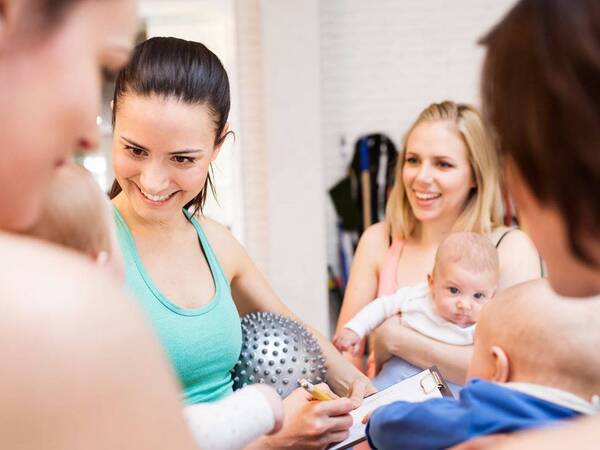 A group of mom and babies participate in an exercise class designed to strengthen mom's pelvic floor after childbirth.