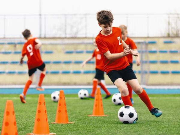 Young children learning to play soccer the right way to prevent accidents and injuries.