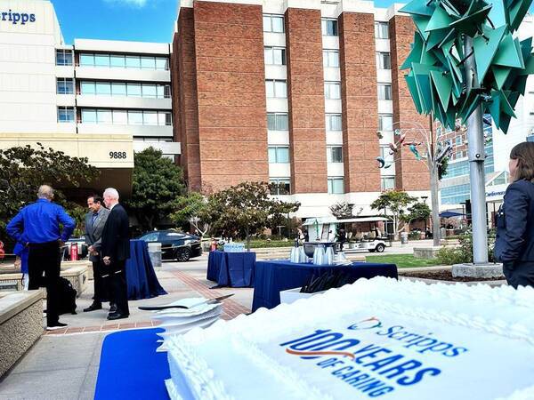 A cake displays Scripps 100 Years of Caring outside of Scripps Memorial Hospital La Jolla. 