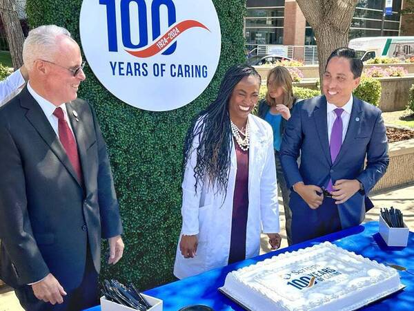 Scripps Health President and CEO Chris Van Gorder, from left, Scripps Memorial Hospital La Jolla Chief of Staff Ayana Boyd King, DO, and San Diego Mayor Todd Gloria prepare to cut a special cake celebrating the 100th Anniversary of Scripps. 