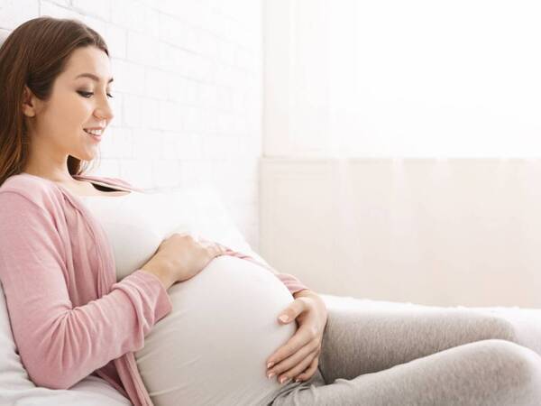 A pregnant woman rests at home at 34 week pregnancy point.