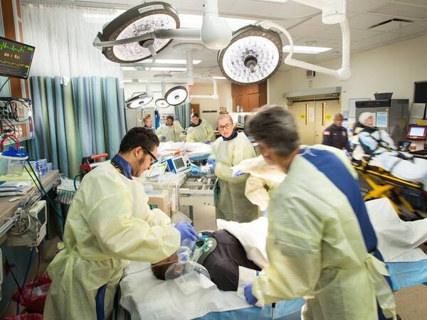 Providers in the emergency room caring for a patient who has suffered trauma.