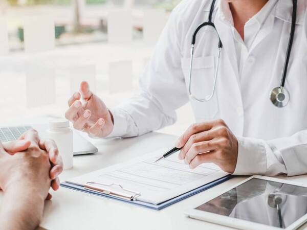 A physician and patient discuss test results for epilepsy.