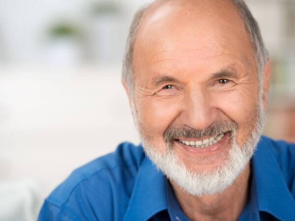 A smiling mature man represents the full life that can be led after prostate cancer treatment.