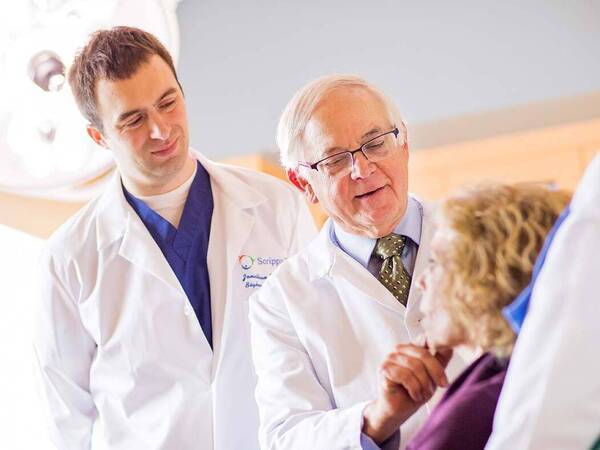 Scripps physicians examine a patient, representing the range of skin cancer treatment options at Scripps.
